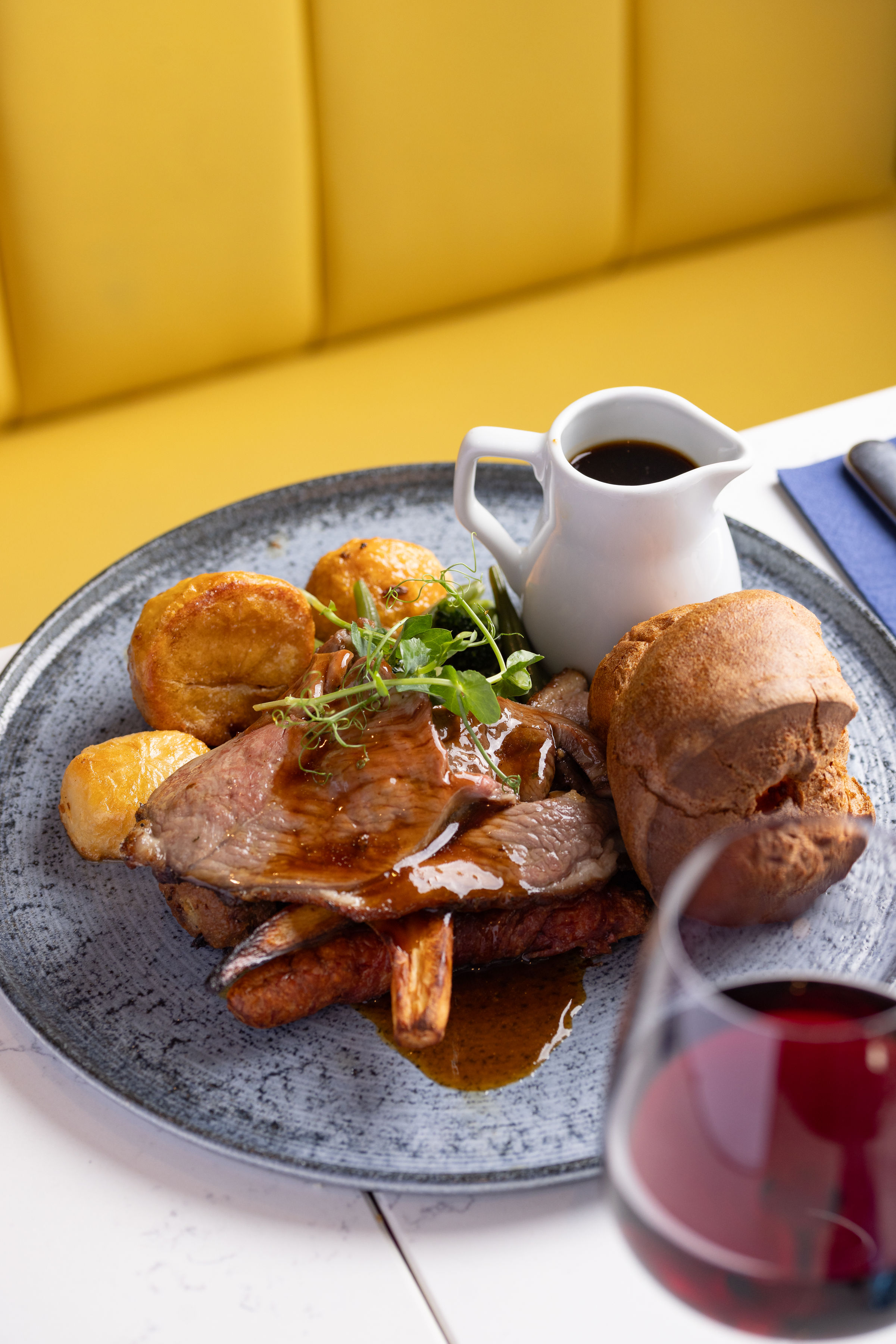 Plated Sunday roast with yorkshire pudding and gravy at Banana Wharf